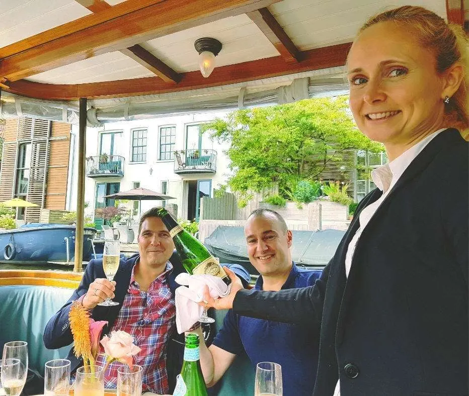 Chantal serving champagne to guests on board a private canal boat