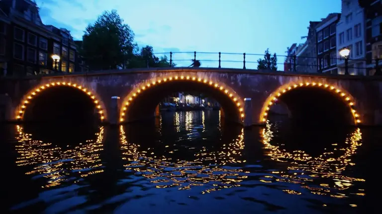 Amsterdam canal bridges illuminated after dark