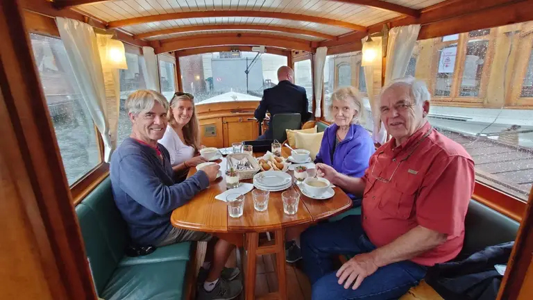 Guests having lunch on a private canal cruise
