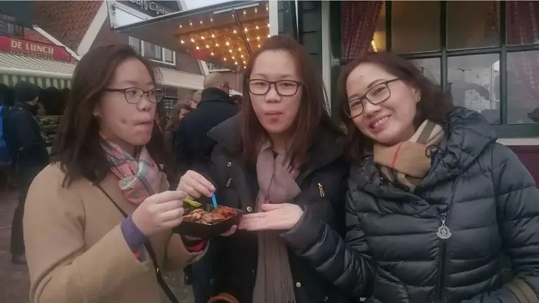 Guests tasting poffertjes in Amsterdam