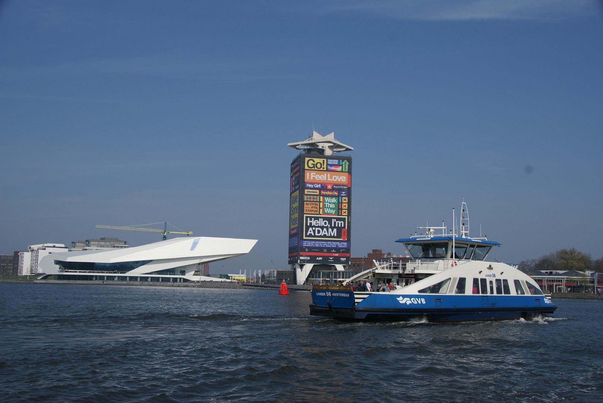 A ferry passing the Amsterdam waterfront by the A’DAM Tower