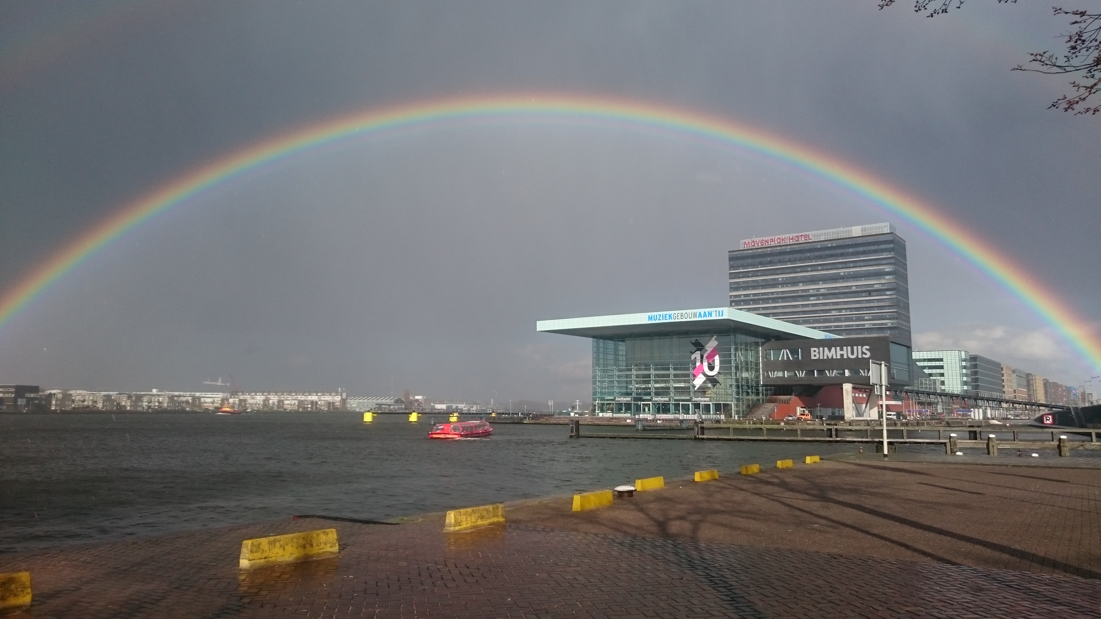 A rainbow over Amsterdam’s modern waterfront by the IJ