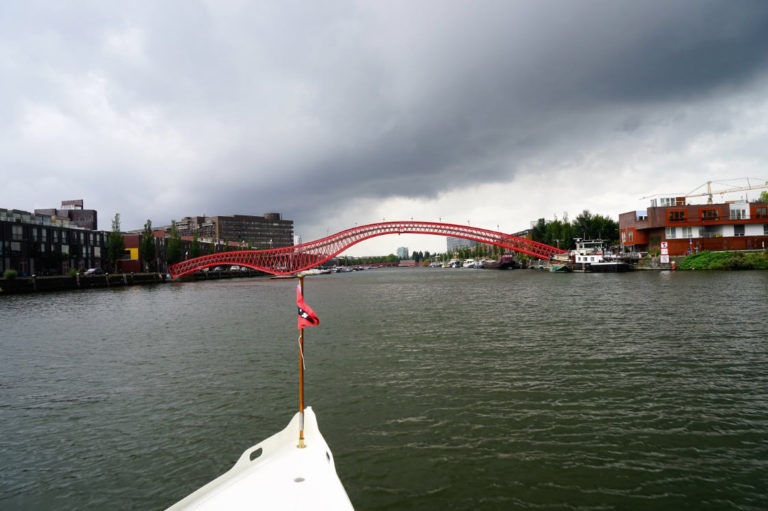 Amsterdam’s red Python Bridge seen from a private architecture cruise