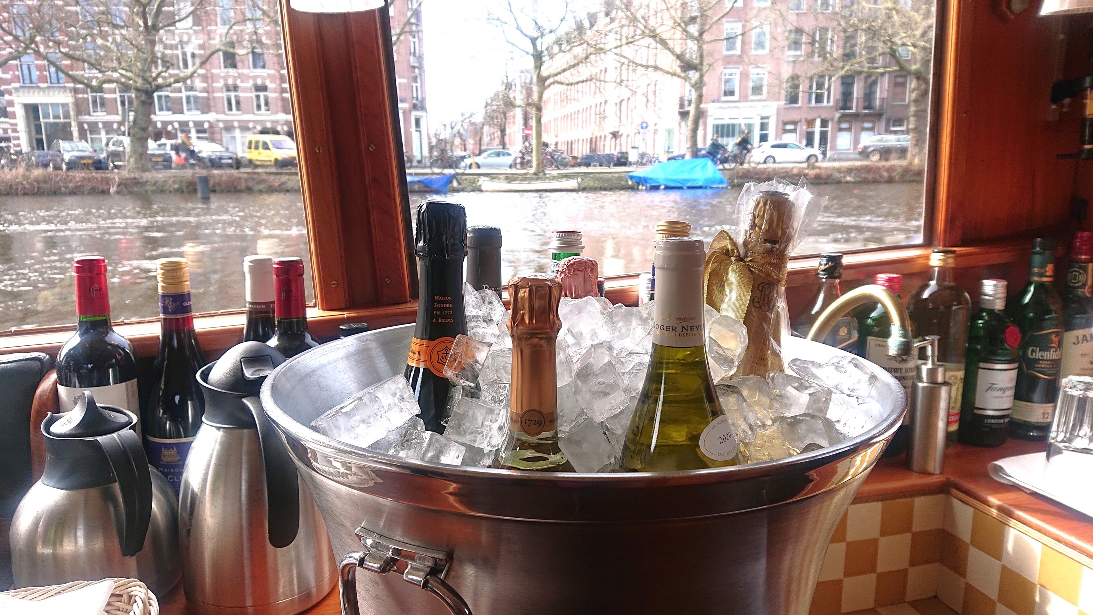 Champagne chilled on board with an Amsterdam canal view
